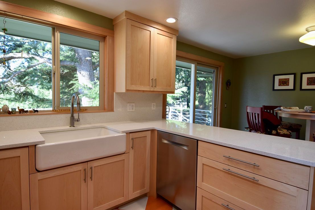 A kitchen with wooden cabinets and a white sink