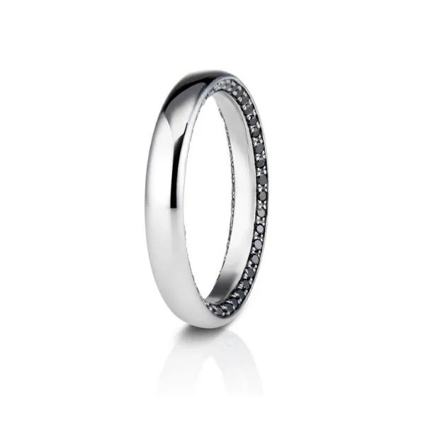 a silver ring with black diamonds on it