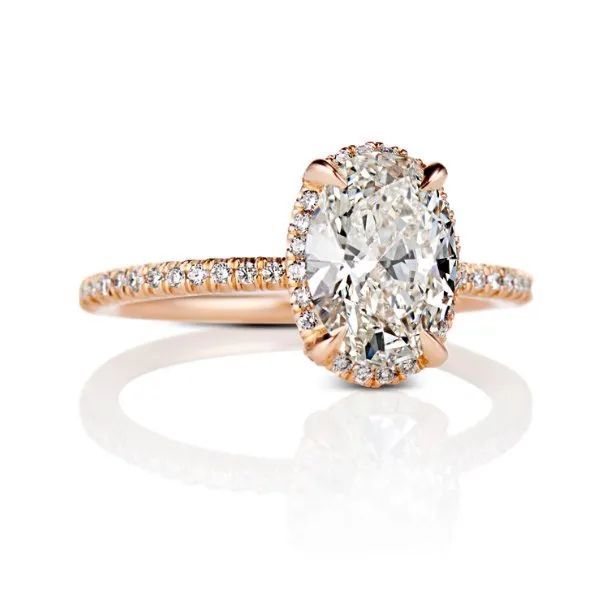 a rose gold ring with an oval diamond in the center