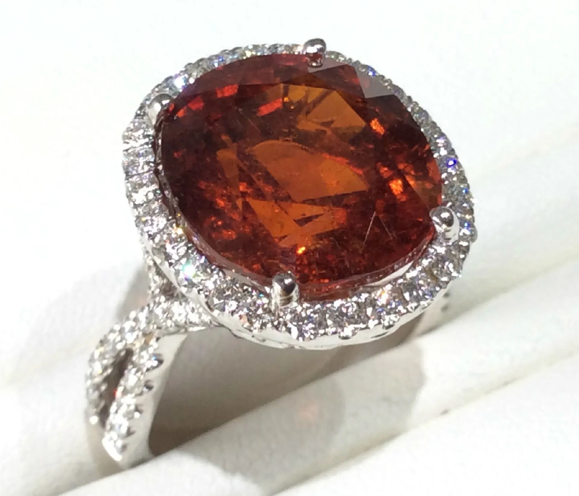a silver ring with a large orange stone in the center