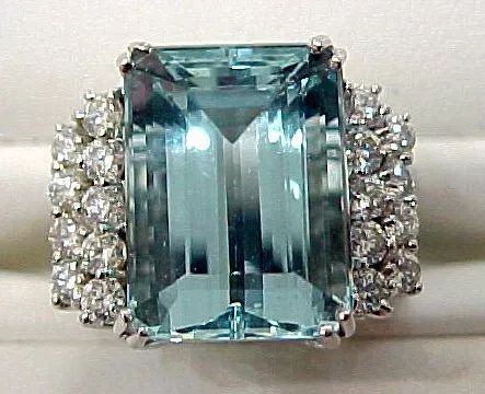 a ring with a large aquamarine and diamonds