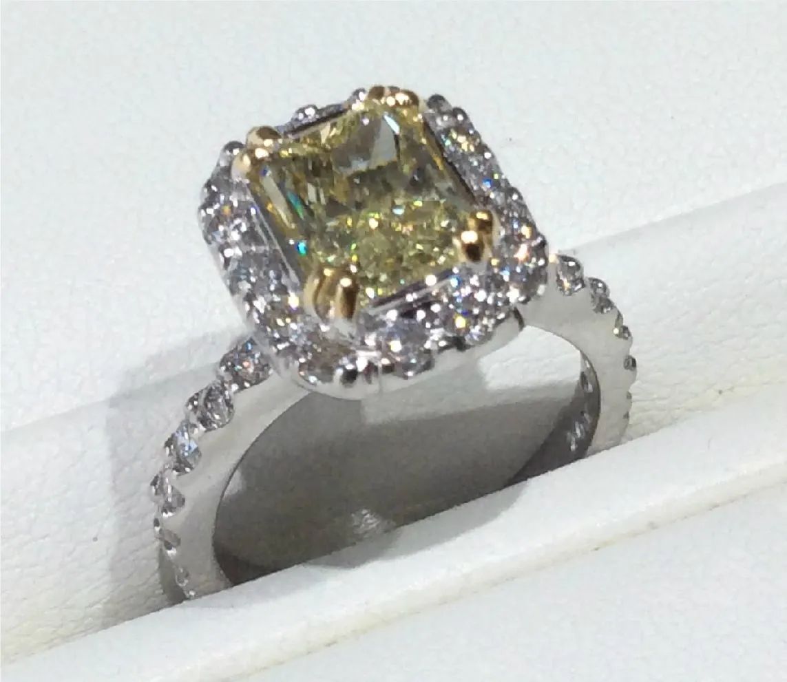 a ring with a yellow diamond in the center