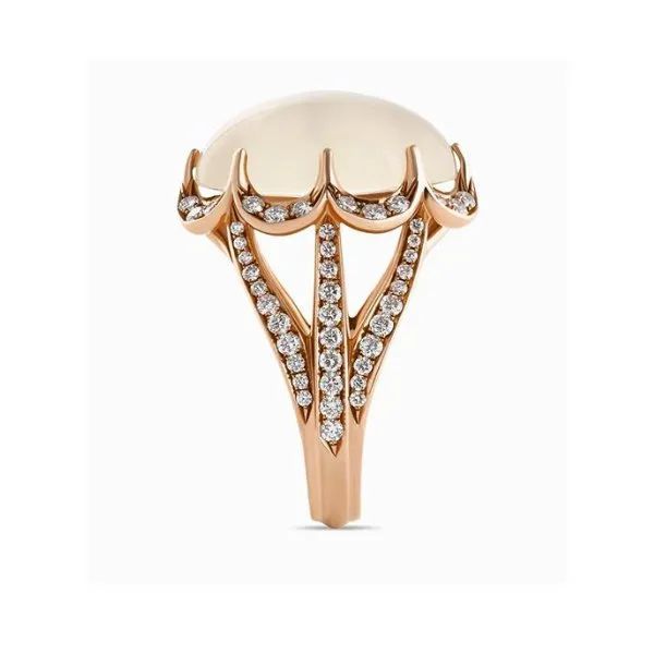 a ring with a pearl and diamonds on a white background