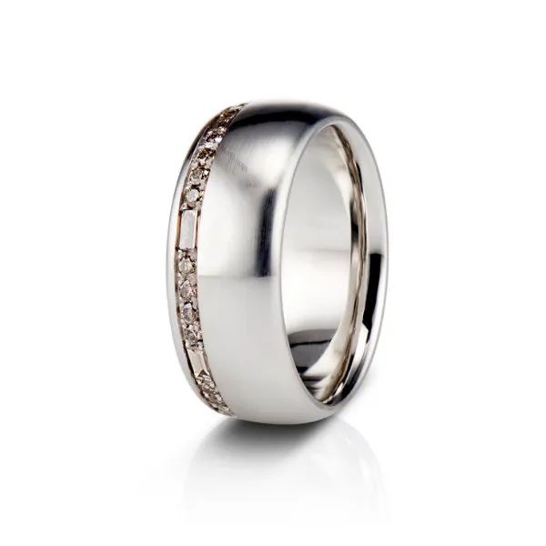 a silver ring with brown diamonds on it