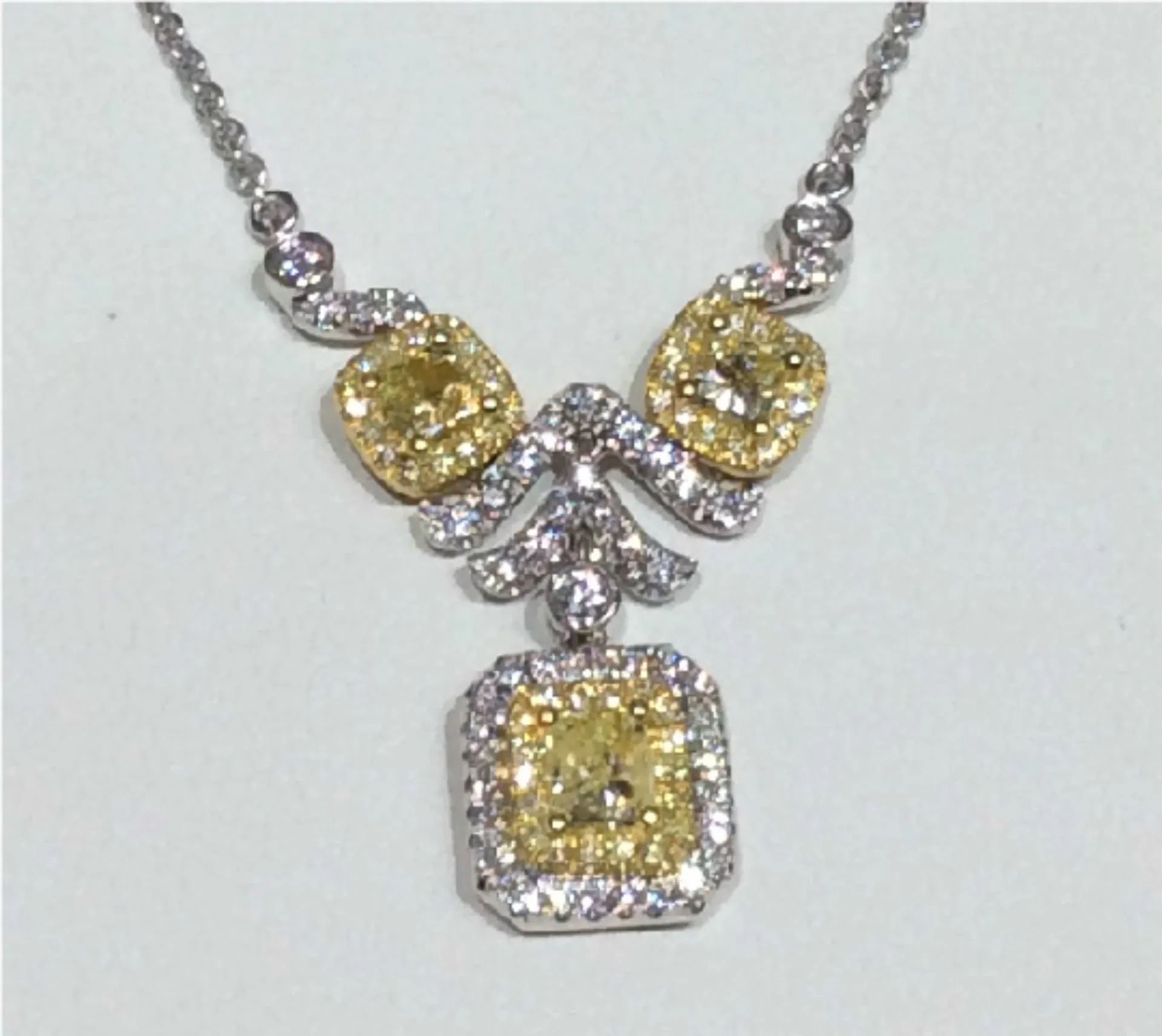 a necklace with yellow diamonds and white diamonds