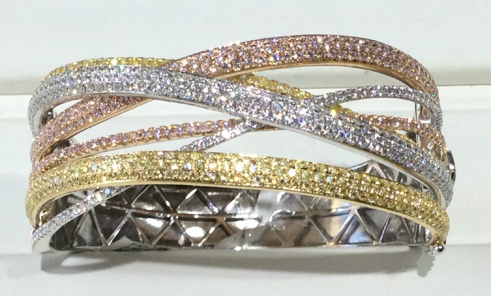 a close up of a bracelet with diamonds on it