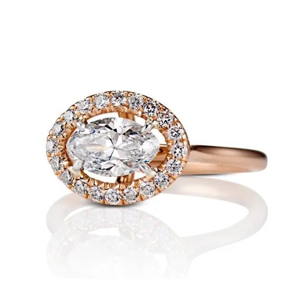 a diamond ring with a oval diamond in the center