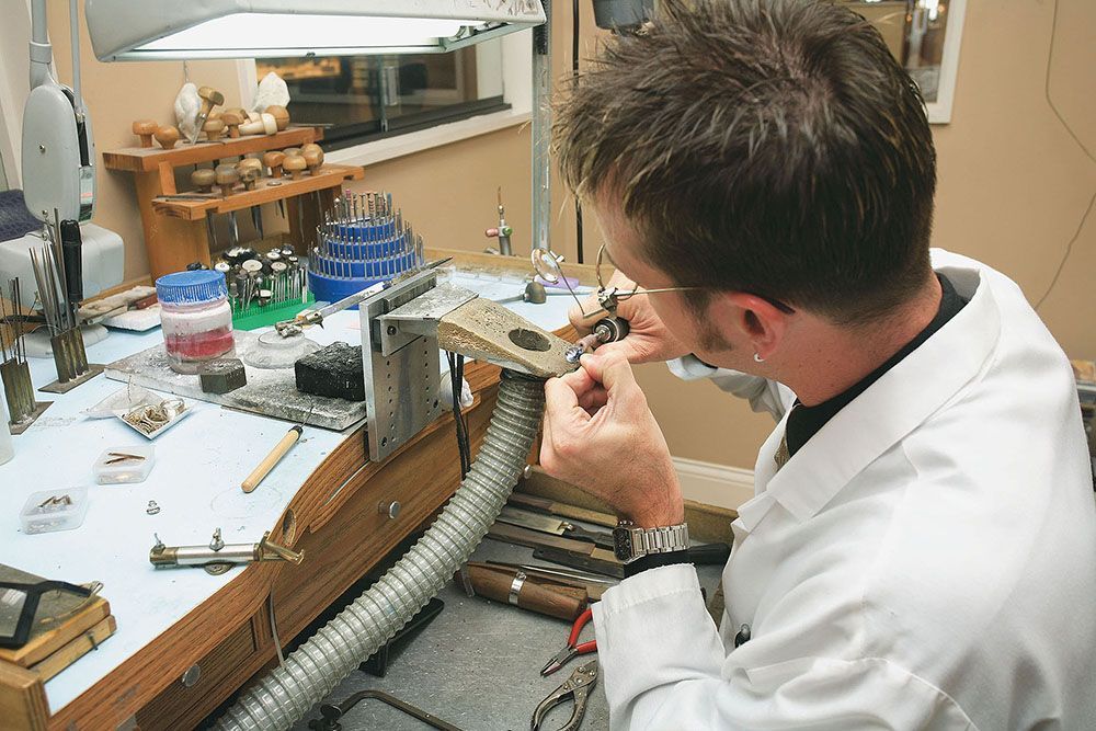 a man inspecting a jewelry.