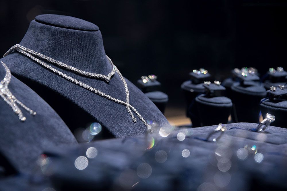 a necklace and ring are on display on a mannequin in a jewelry store.