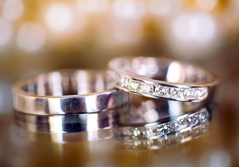 a close up of a pair of wedding rings on a table.