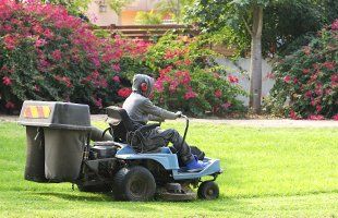 Person riding a mower