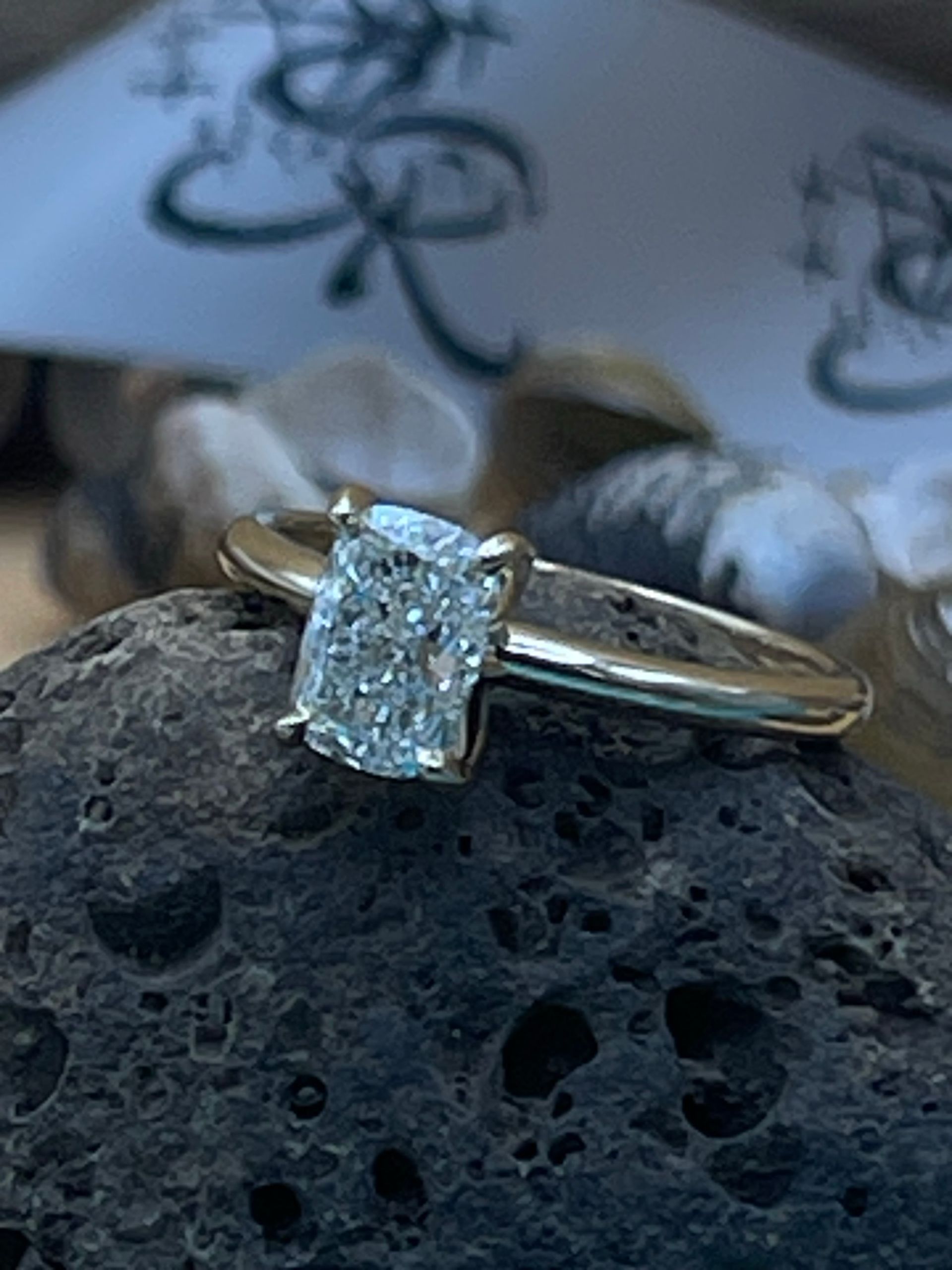 A diamond ring is sitting on top of a rock.