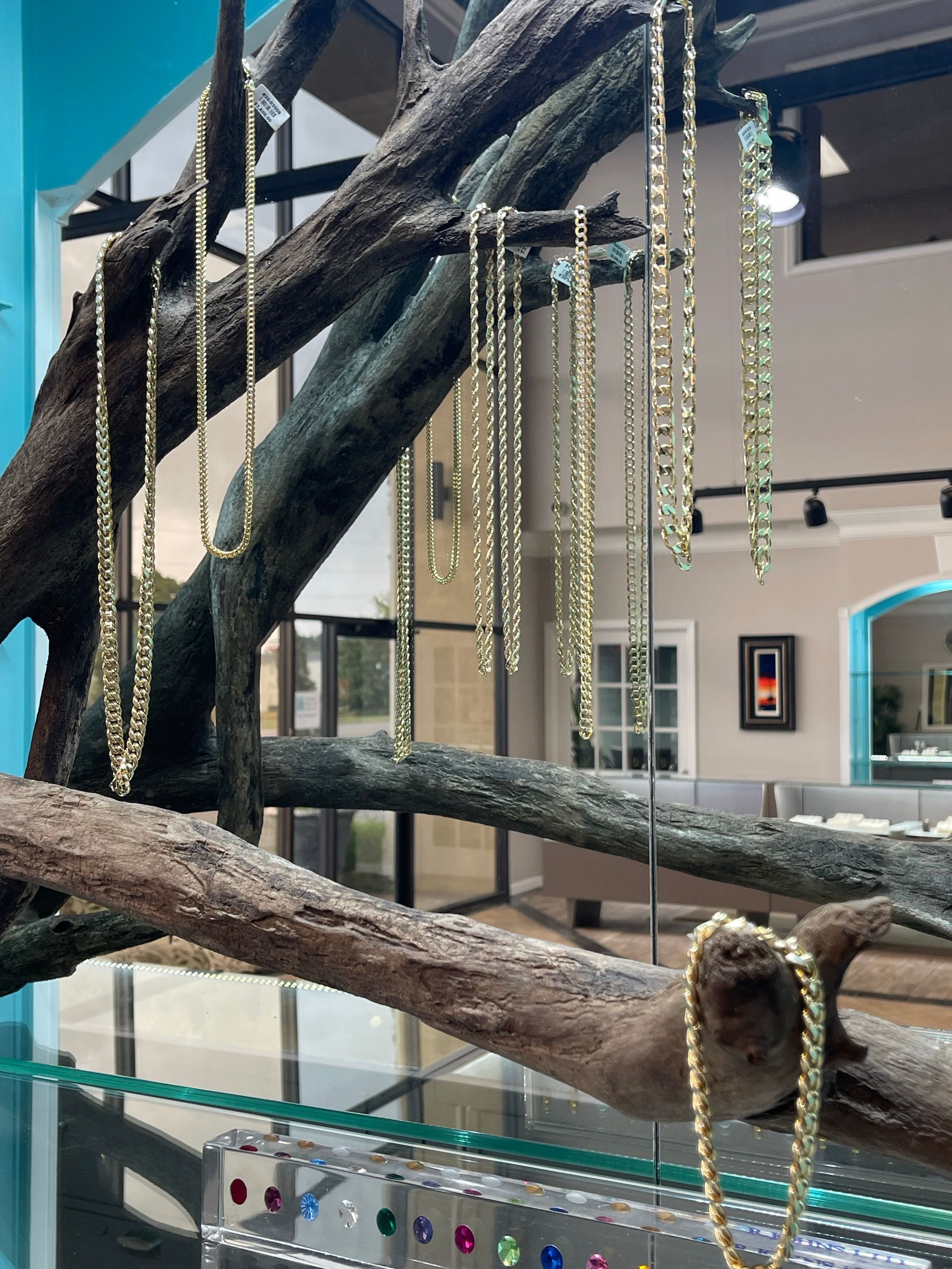 A tree branch with necklaces hanging from it