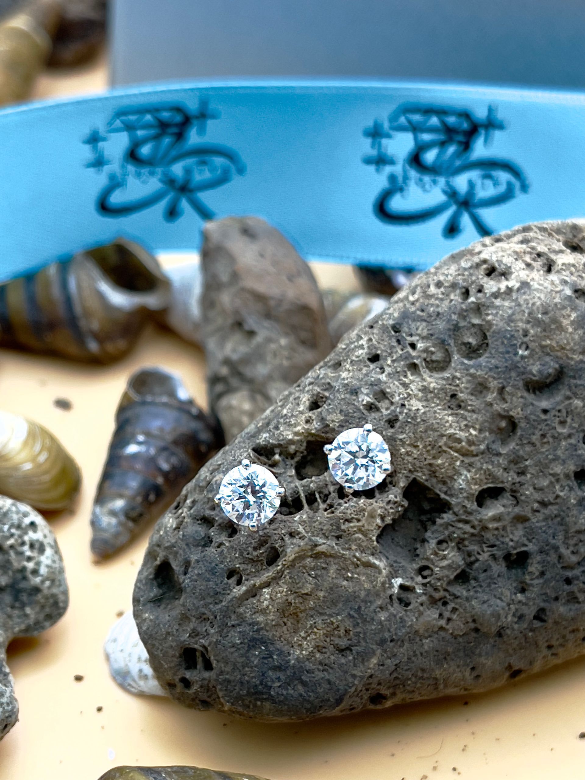 A close up of a rock with a pair of earrings on it