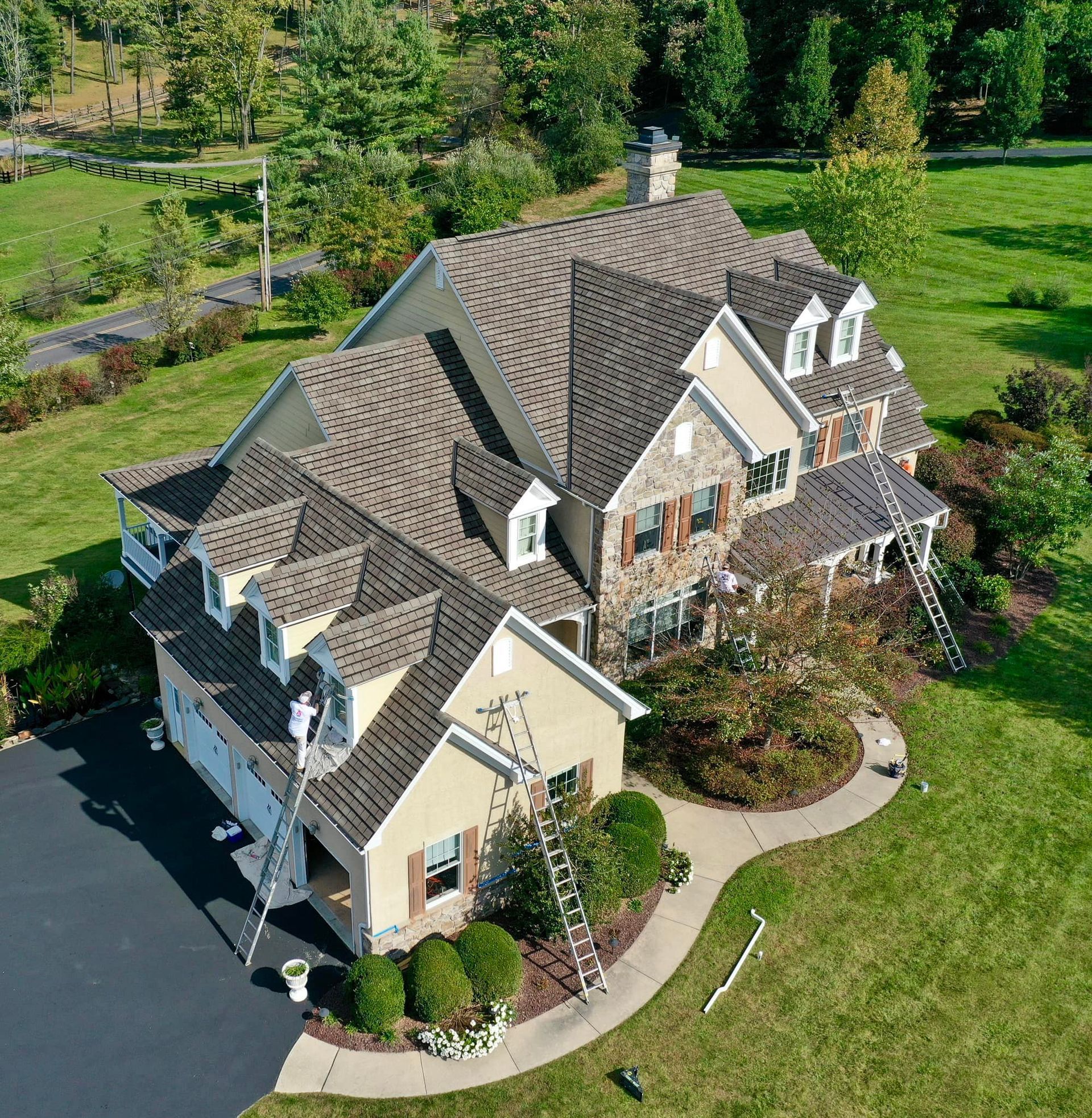 An aerial view of a house that is being painted