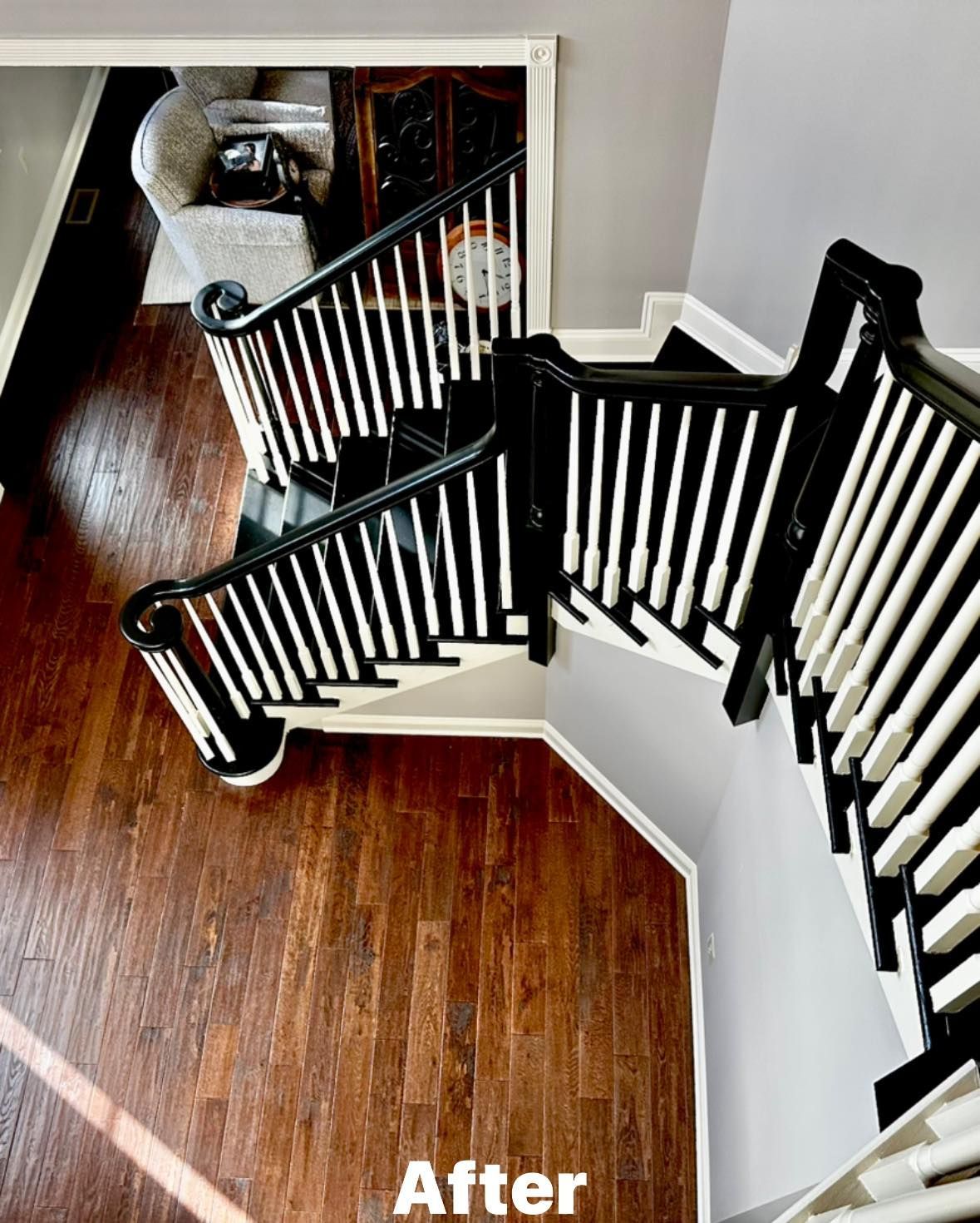 An aerial view of a staircase with a black and white railing.