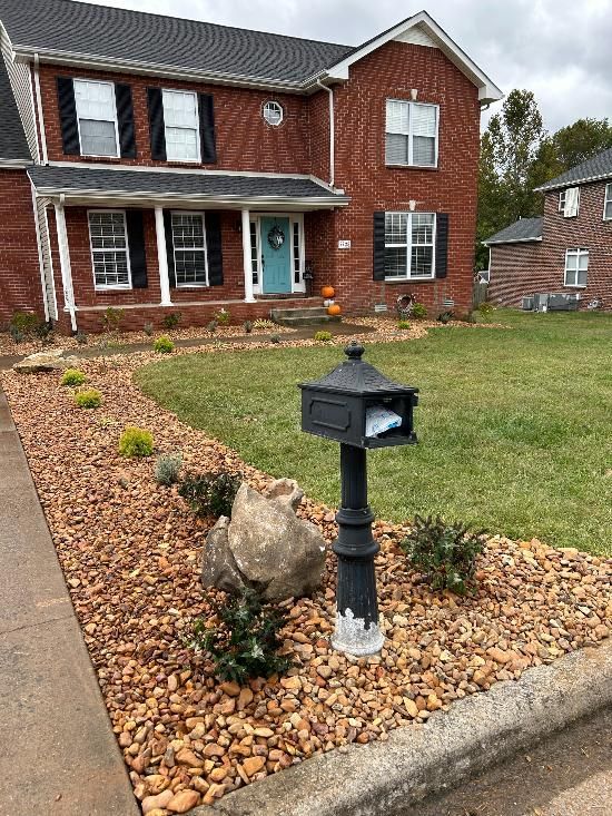 A brick house with a mailbox in front of it.