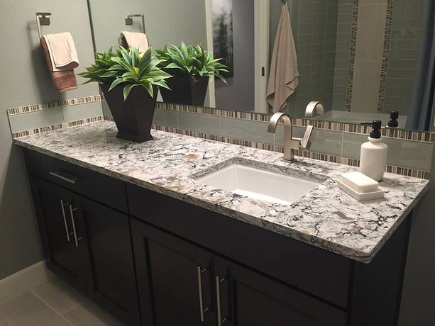 A bathroom vanity with a sink and a mirror.