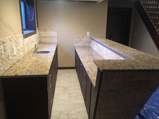 A kitchen with granite counter tops and a sink.