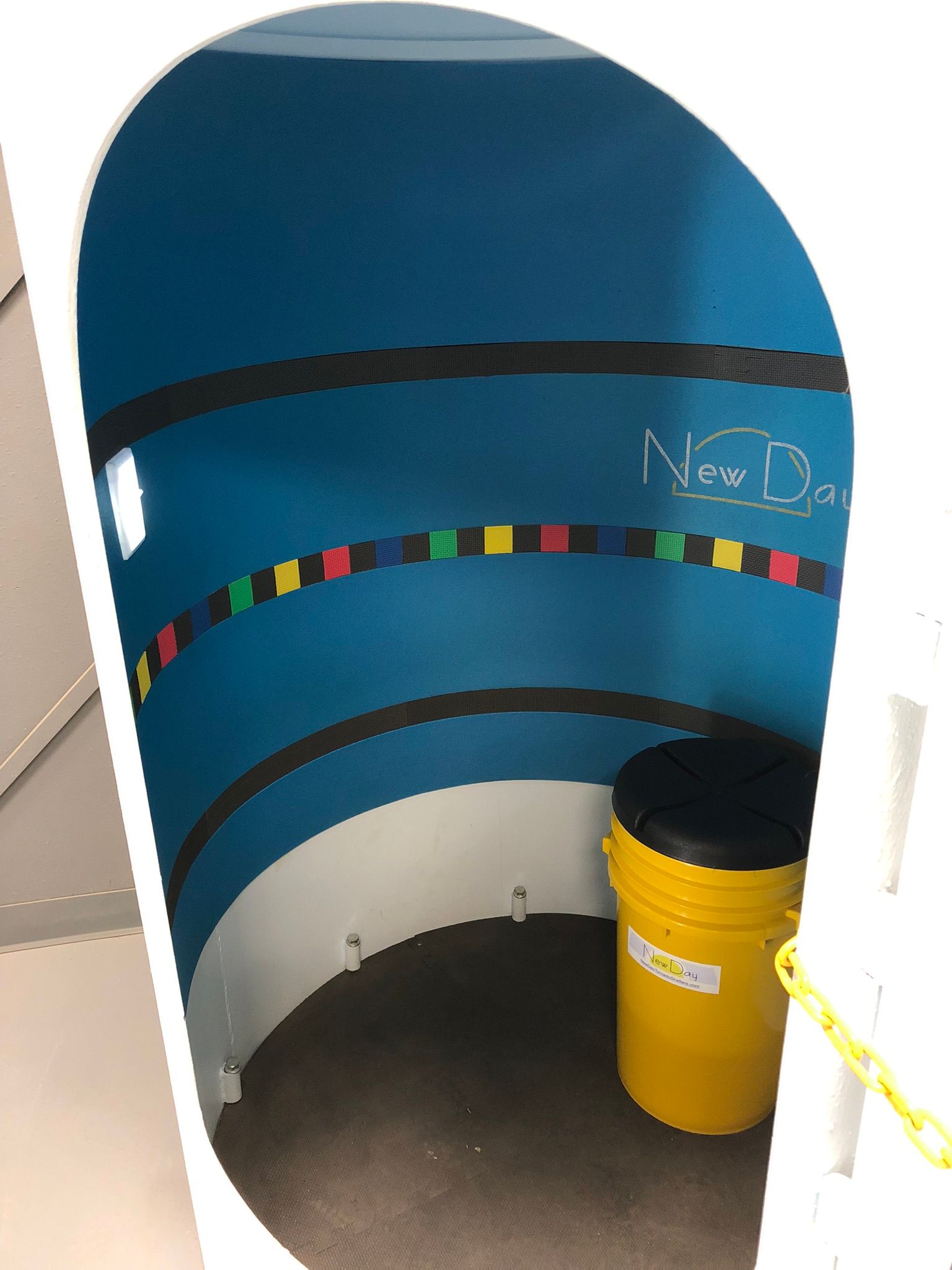 A yellow bucket with the word new day written on it