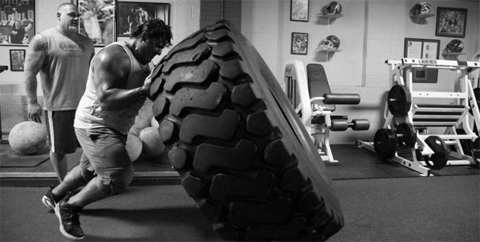 man lifting tire
