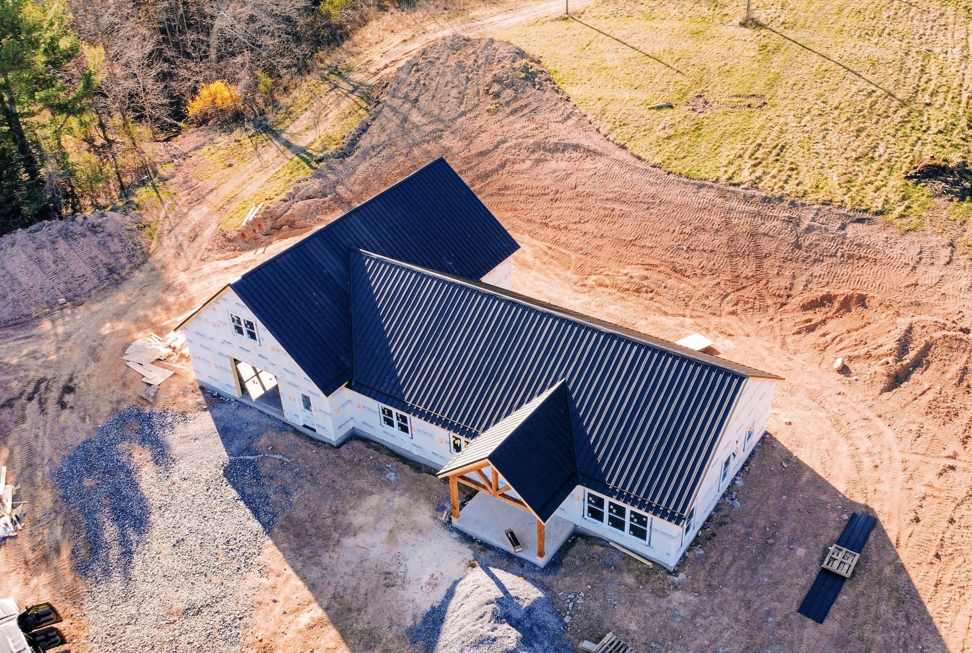 An aerial view of a house under construction in a field.