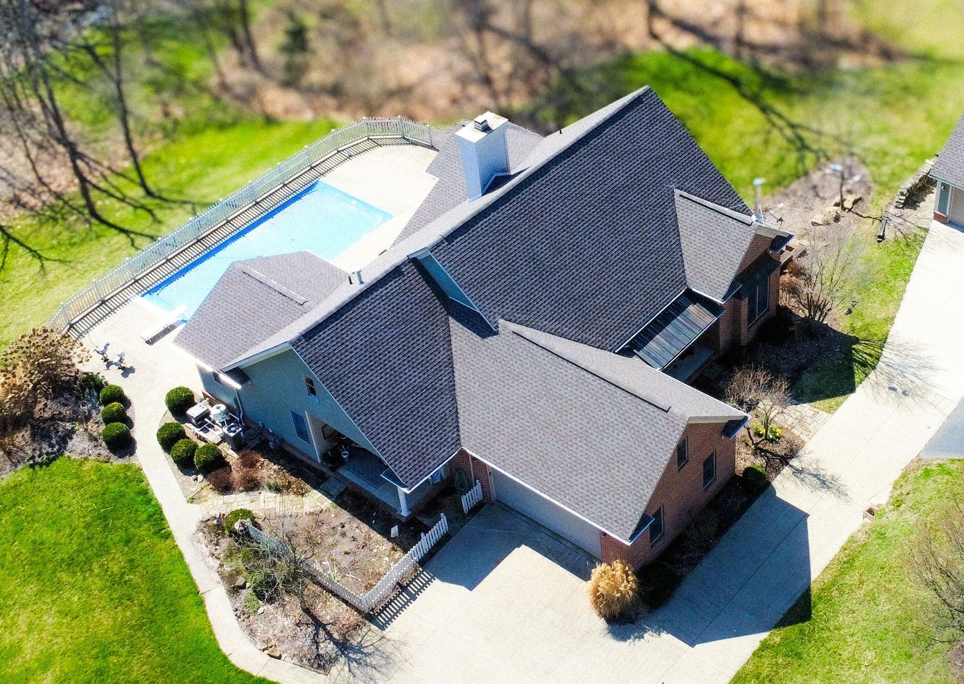 An aerial view of a house with a pool in the backyard.