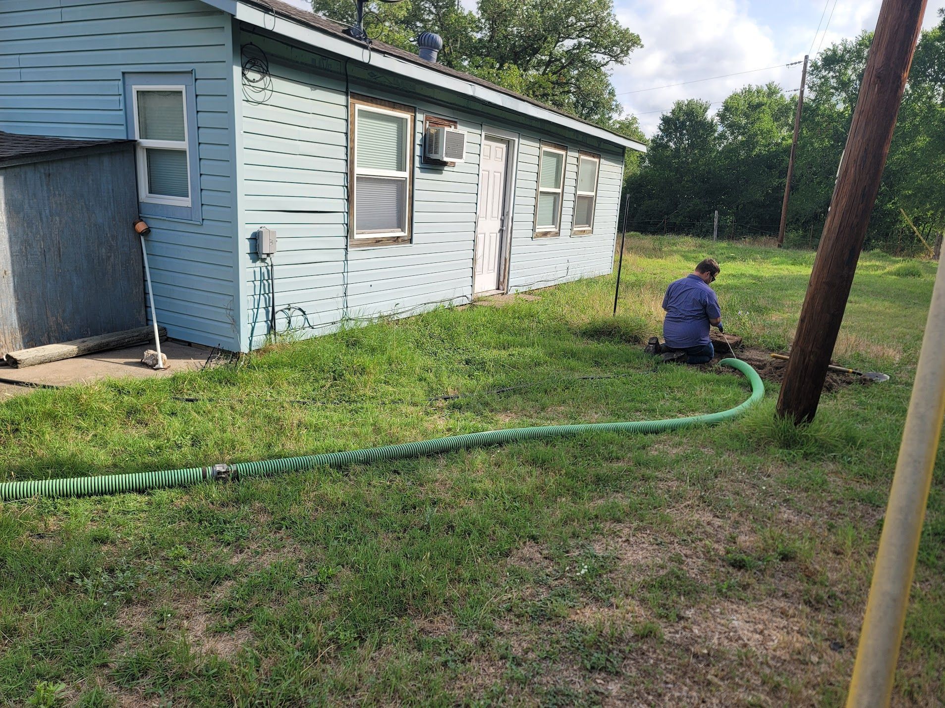man pumping the septic