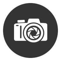 White camera icon with a shutter symbol inside a dark circle