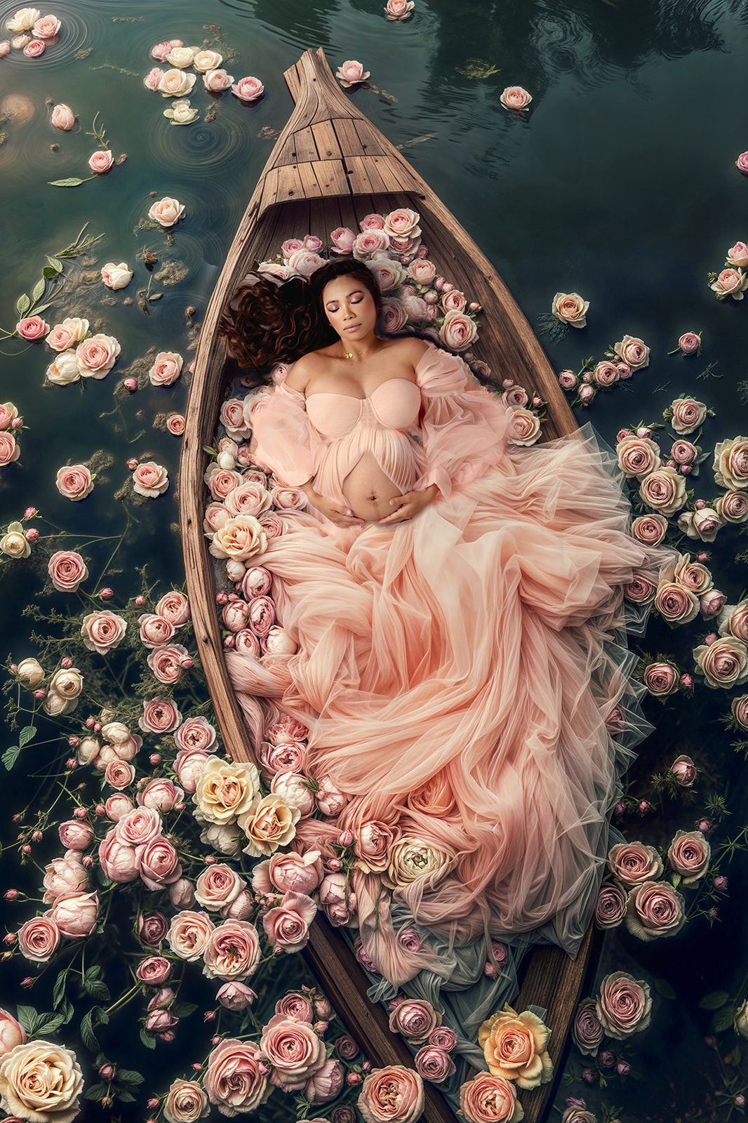 Woman in a pink gown reclining in a boat surrounded by floating flowers on dark water