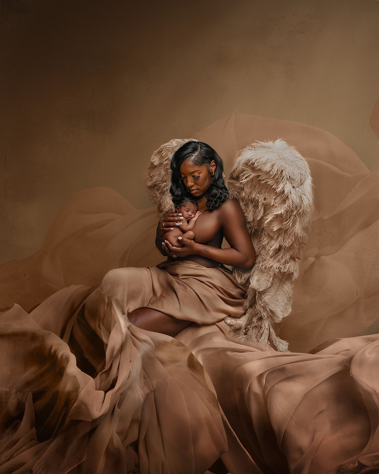 Woman in a flowing brown gown with white feathered wings, seated against a warm brown backdrop.