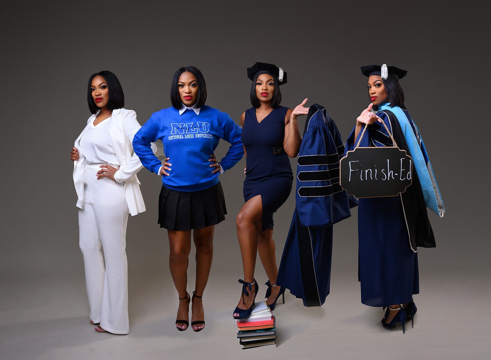 Five fashionably dressed models posing against a gray studio backdrop in blue, white, and black outfits.