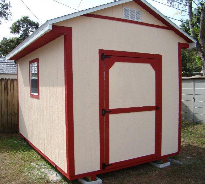 A small shed with a red door and a window