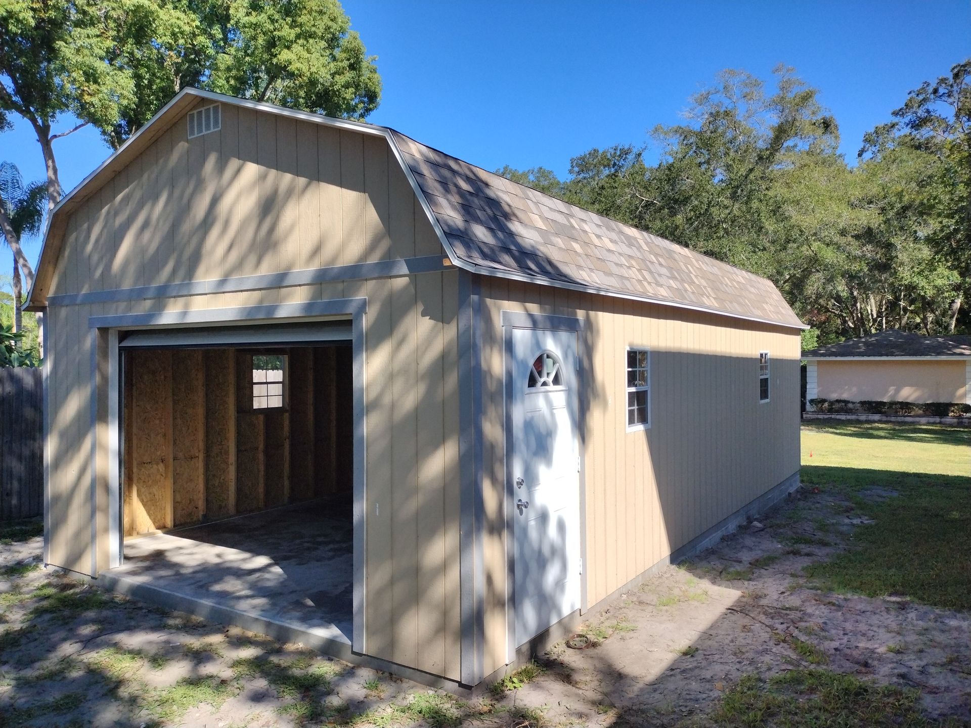 A barn with a garage door and a window