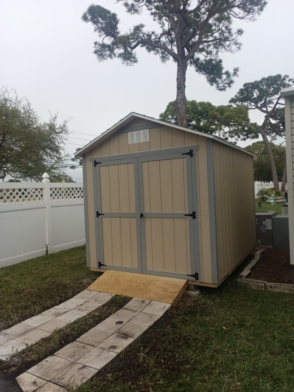 A small wooden shed with a ramp leading to it