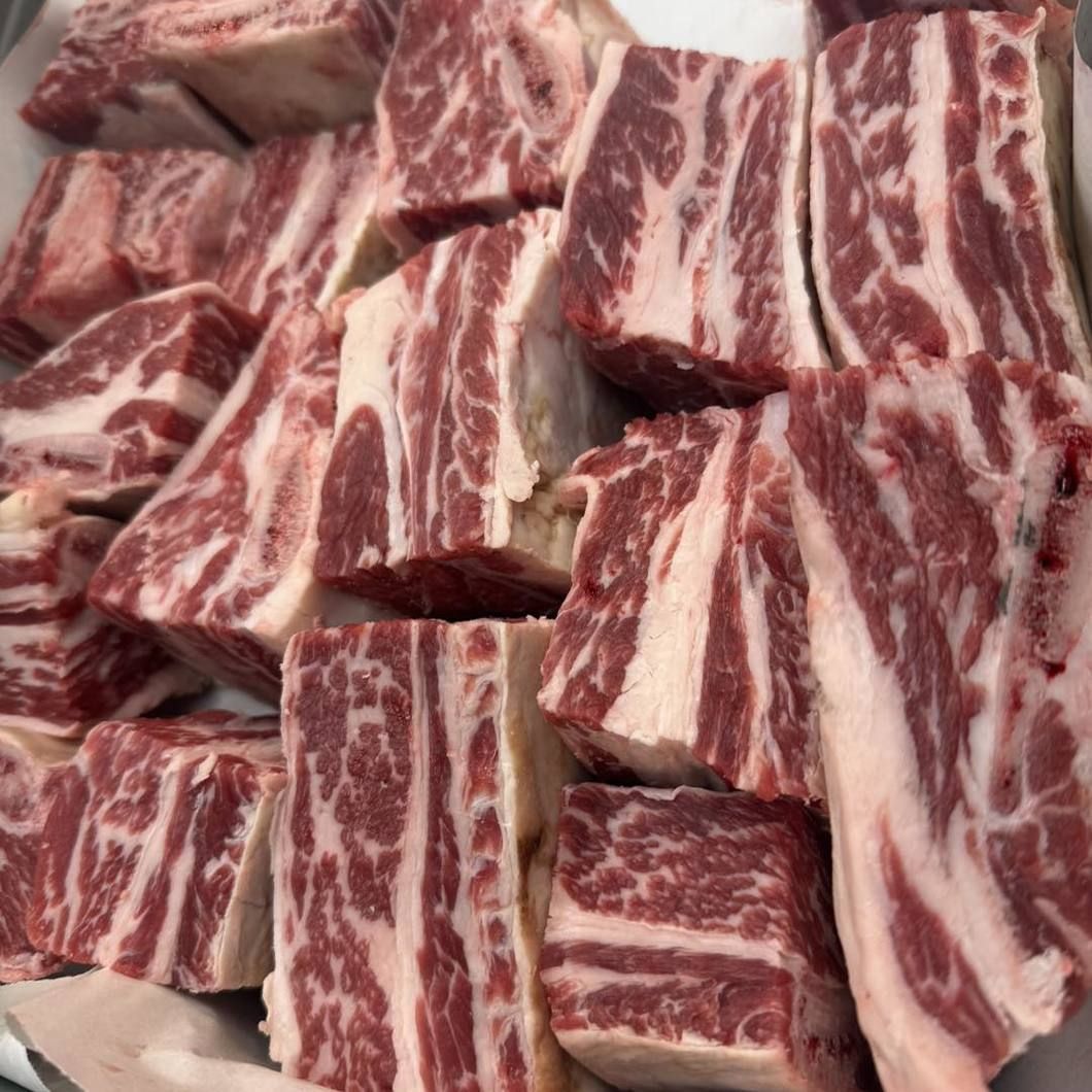 Raw marbled beef short ribs cut into chunks, piled together