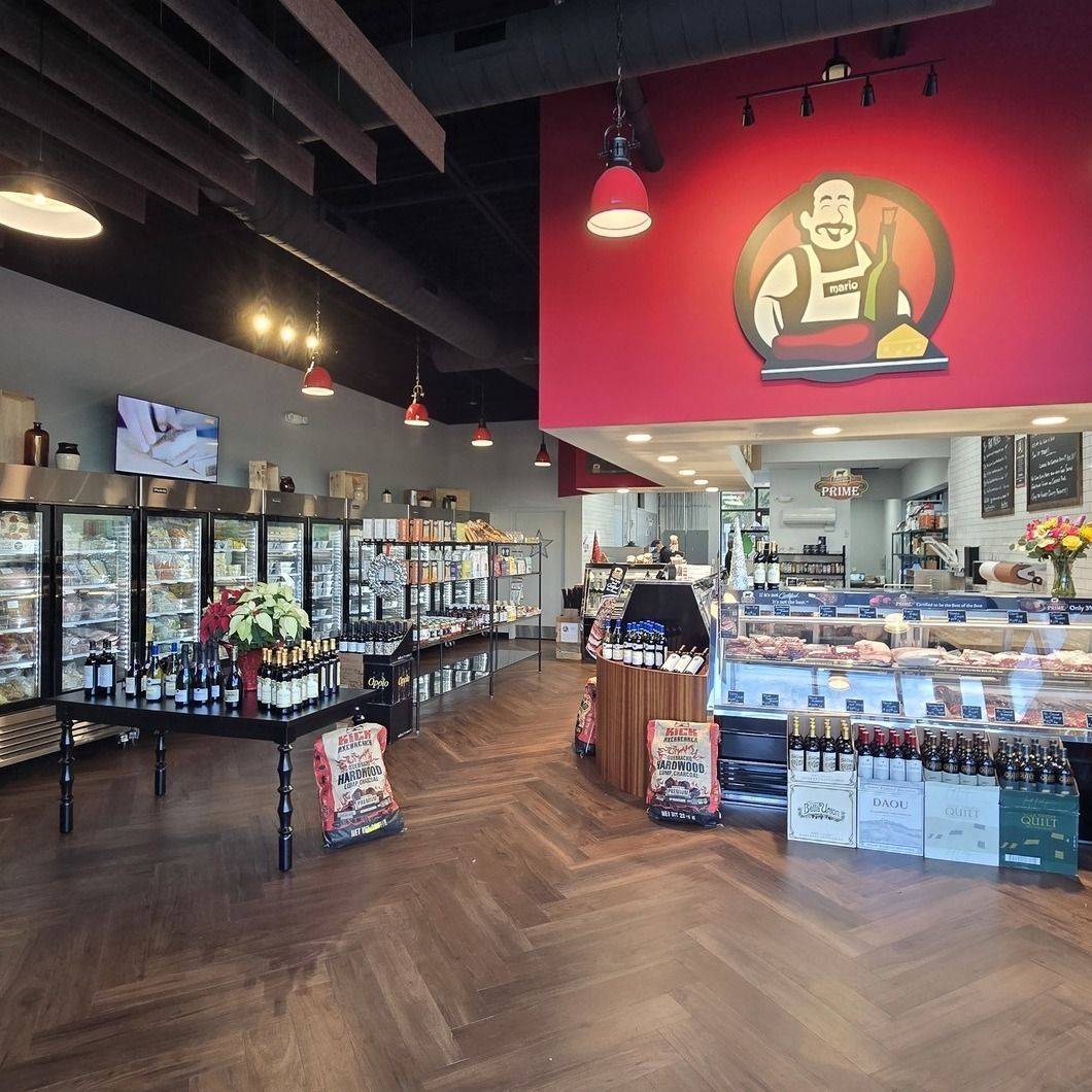 Modern deli market interior with wood floor, glass cases, shelves, and a red wall logo of a chef.