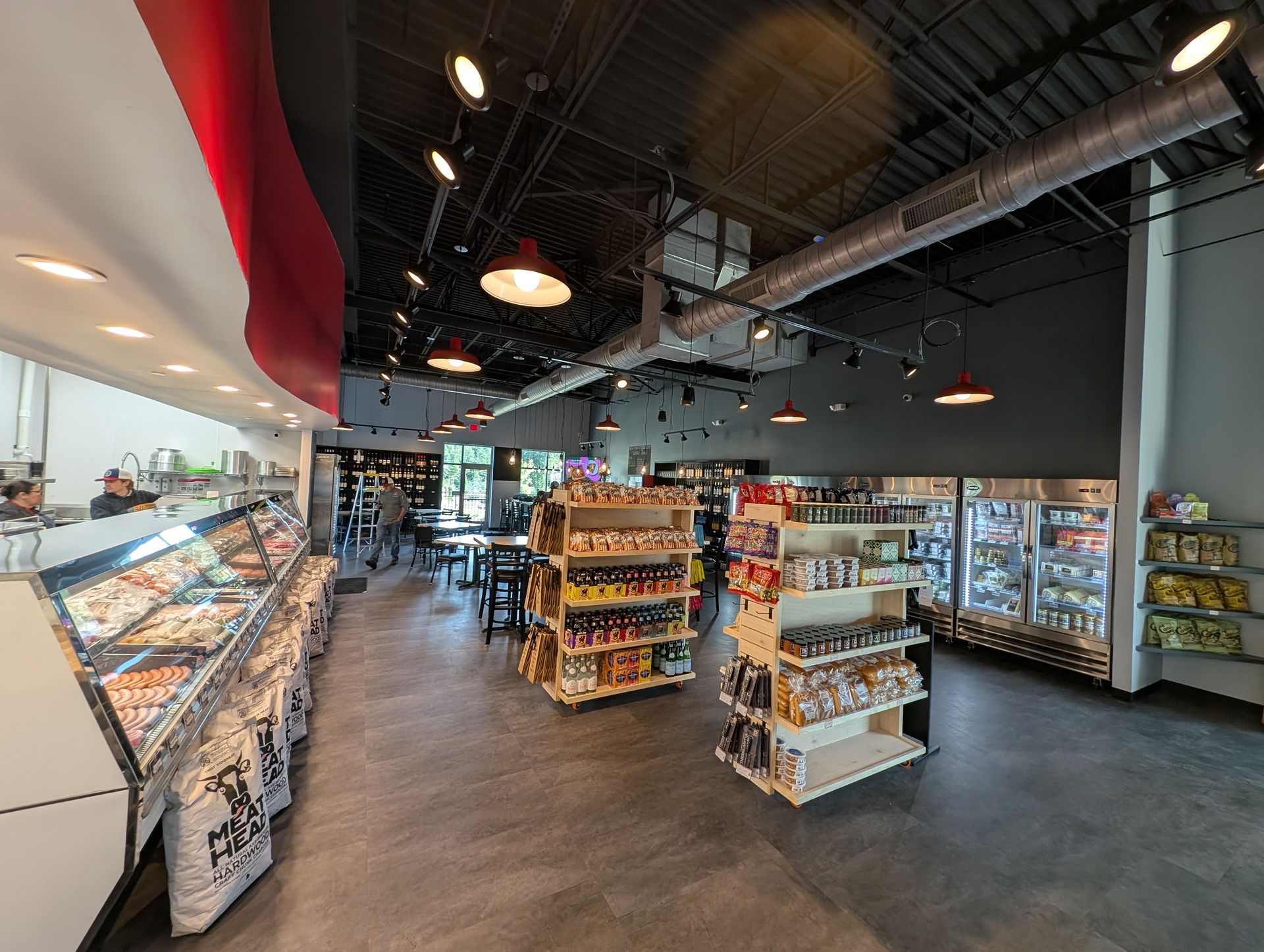 Modern grocery store interior with refrigerated display cases, shelves, and high ceilings