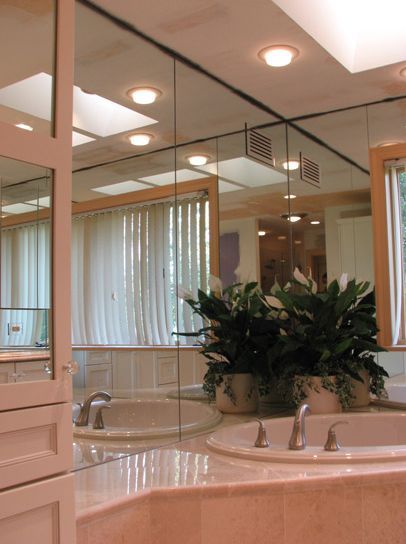 A bathroom with a tub and a mirror