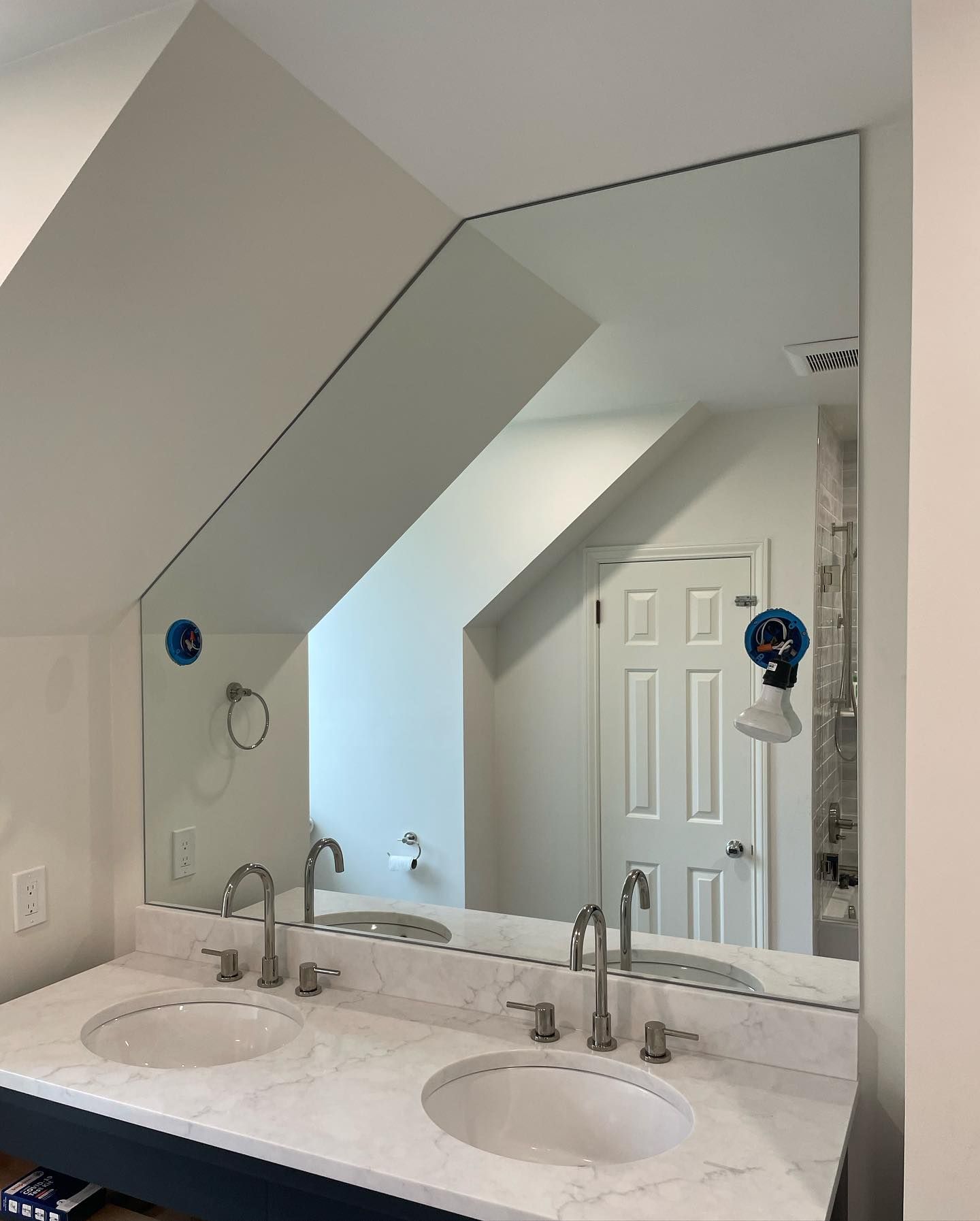A bathroom with two sinks and a large mirror.
