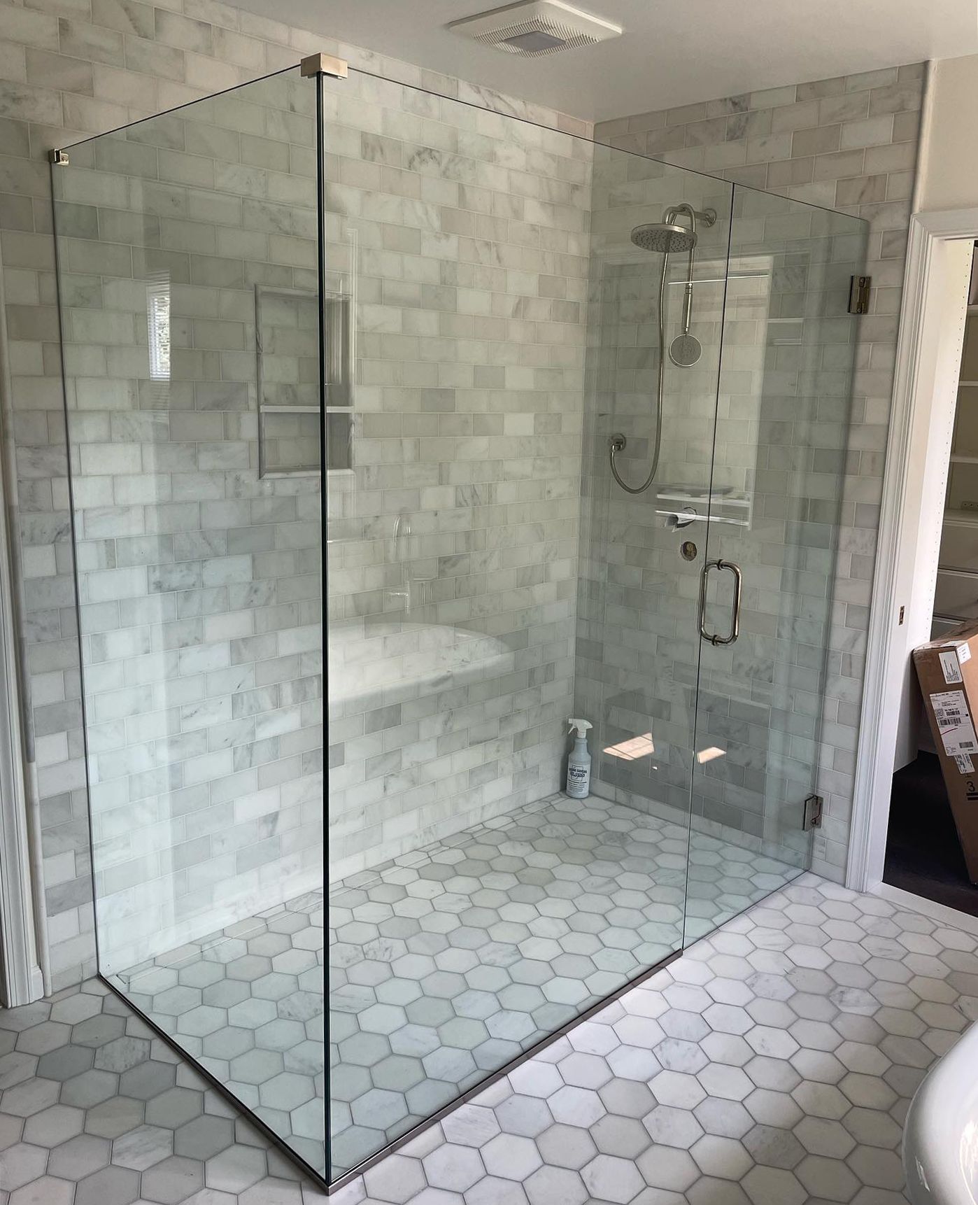 A bathroom with a walk in shower and a bathtub