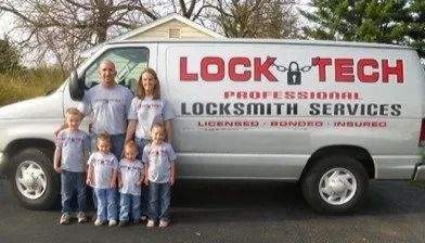 Family stands in front of a Lock Tech van. The van has business logos on the side.