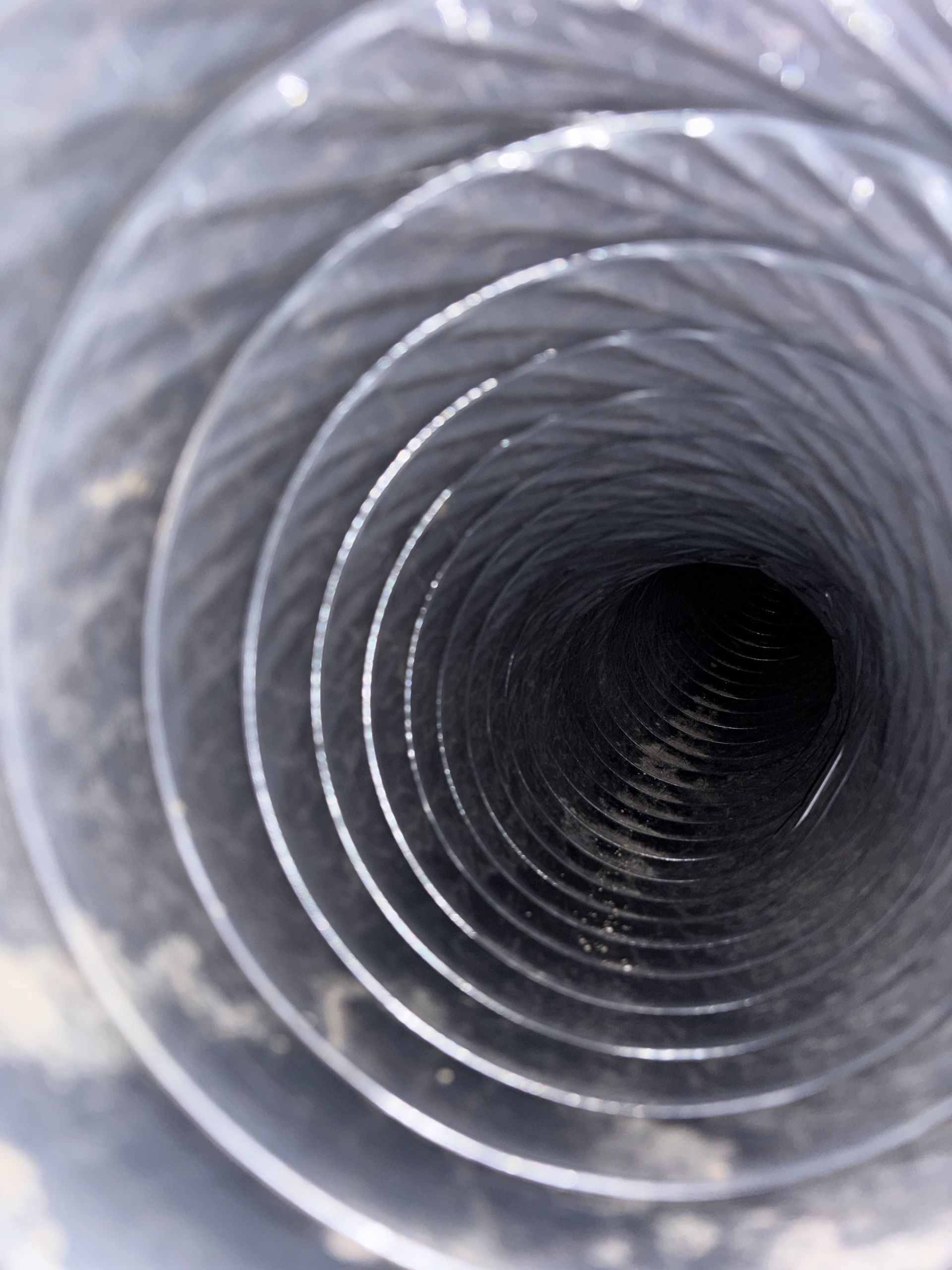 Inside of a coiled metal tube with a dark hollow center