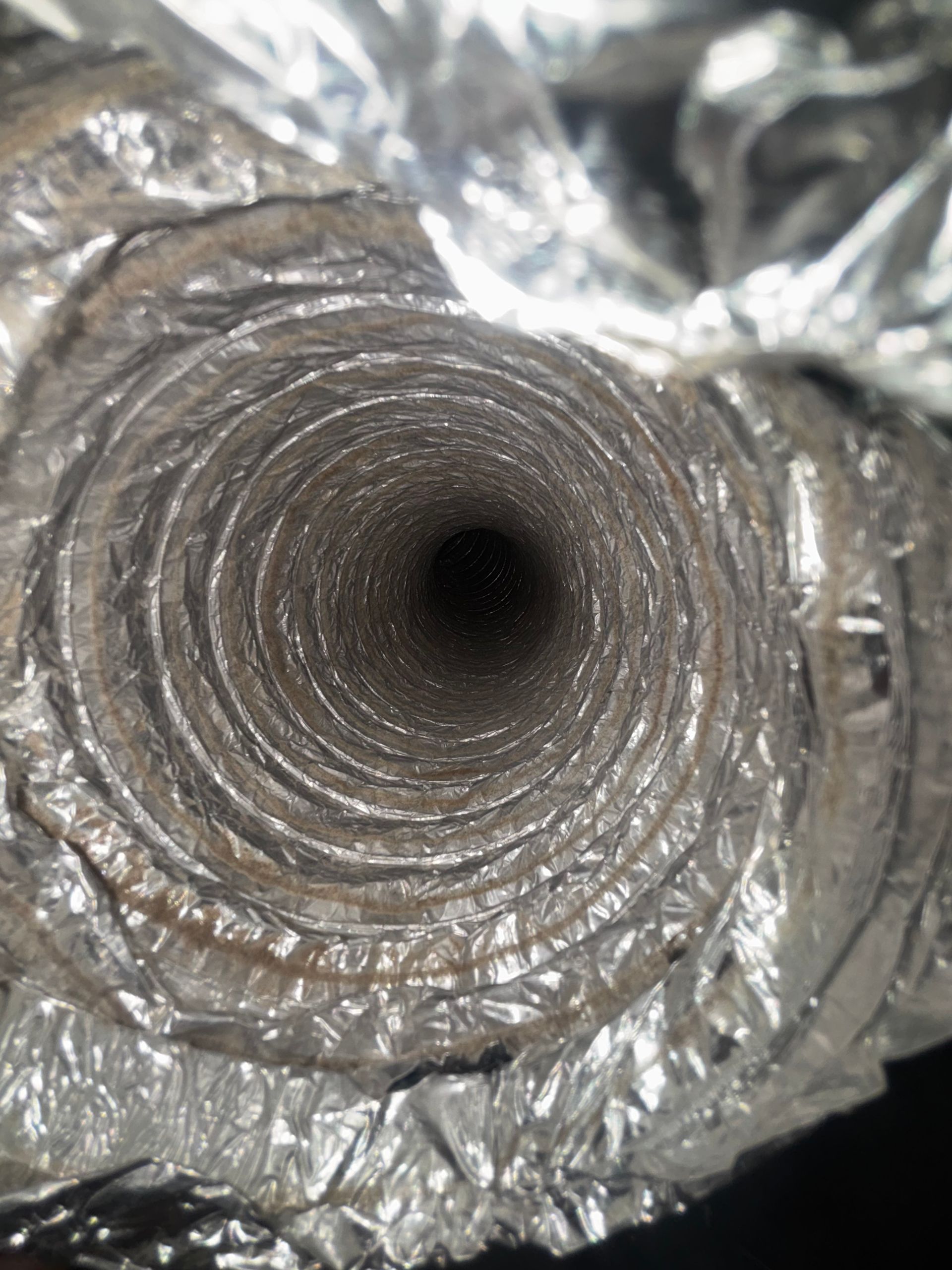 Close-up of a flexible silver ventilation duct interior