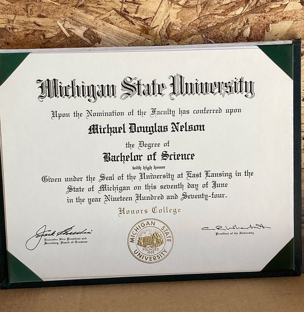 A Michigan State University Diploma is sitting on a table