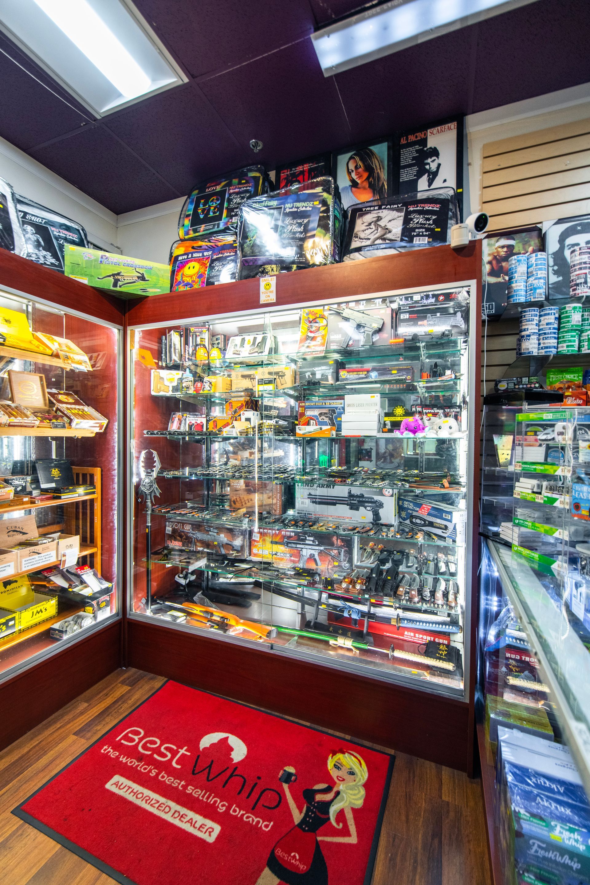 A store filled with lots of toys and a red mat on the floor.