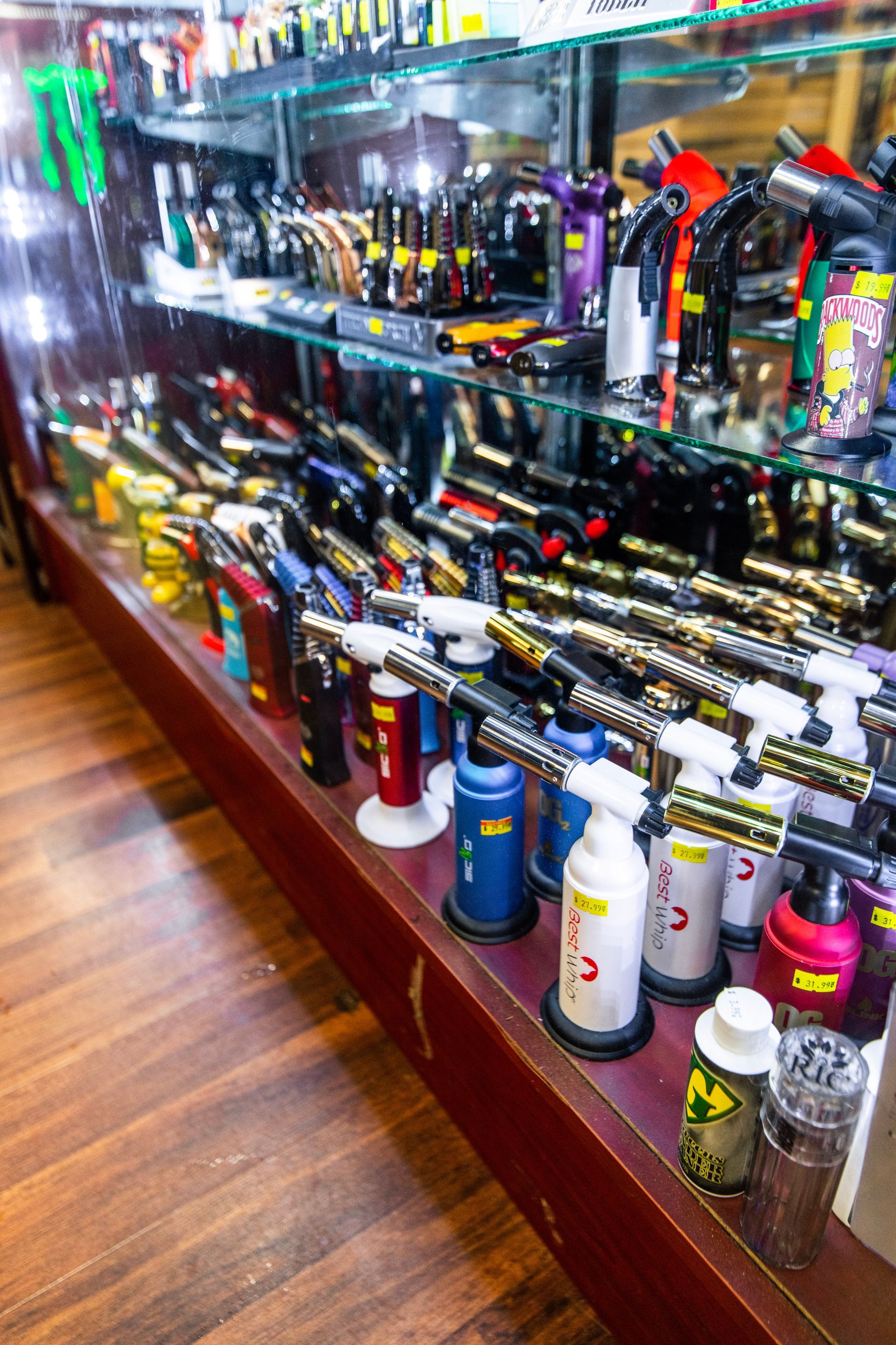 A display case filled with lots of different types of lighter.