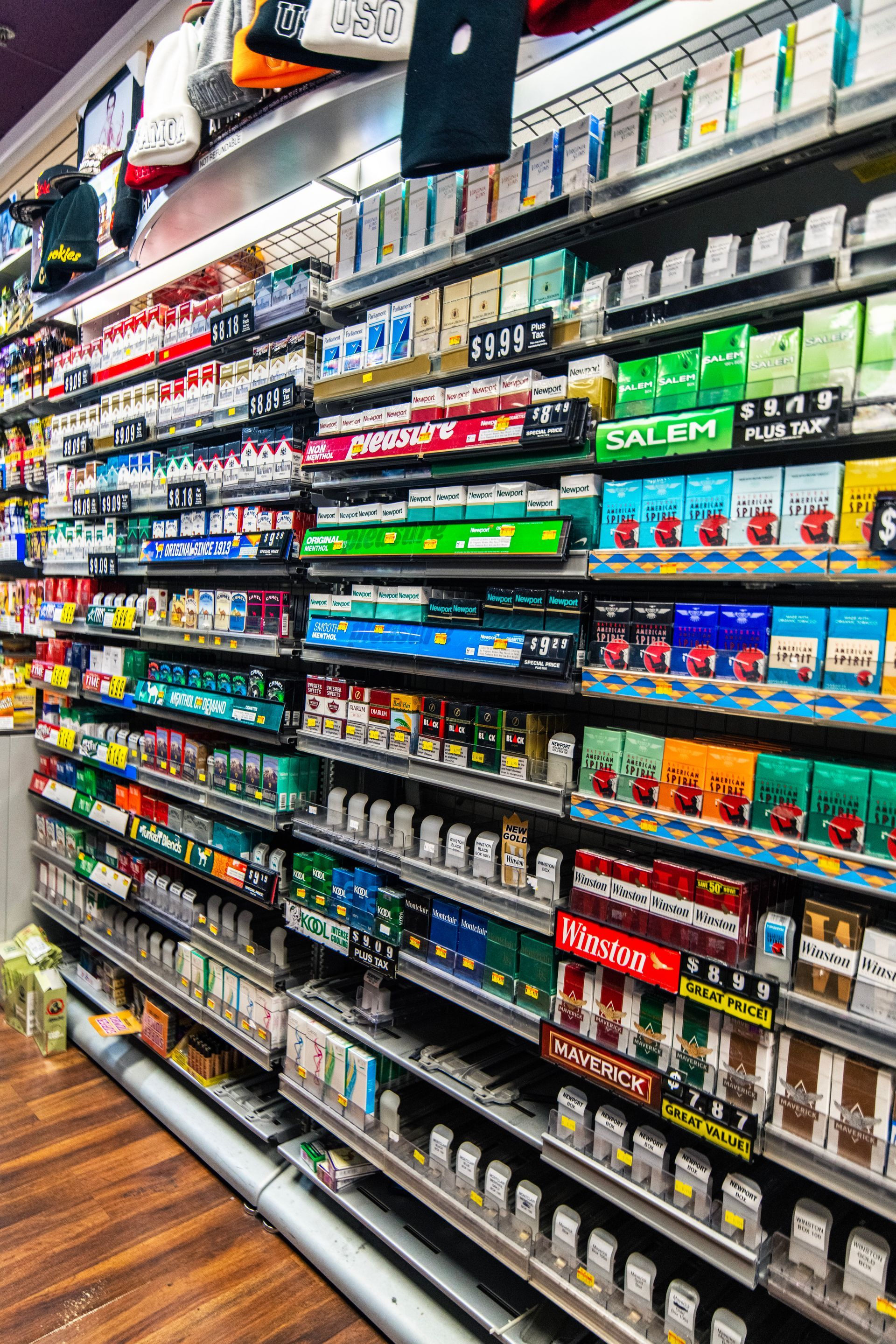 A grocery store aisle filled with lots of cigarettes and other items.