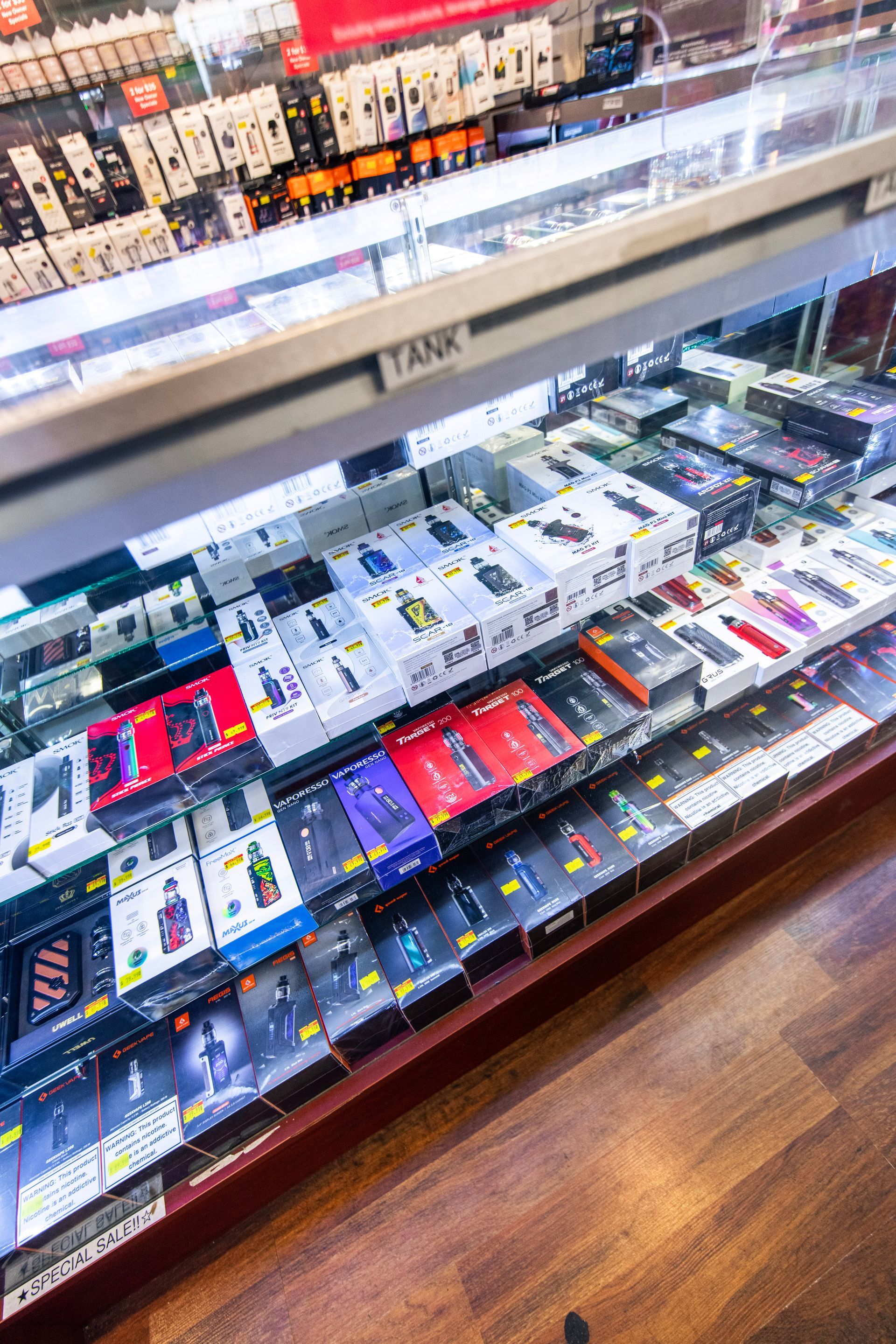 A display case filled with lots of electronic cigarettes in a store.