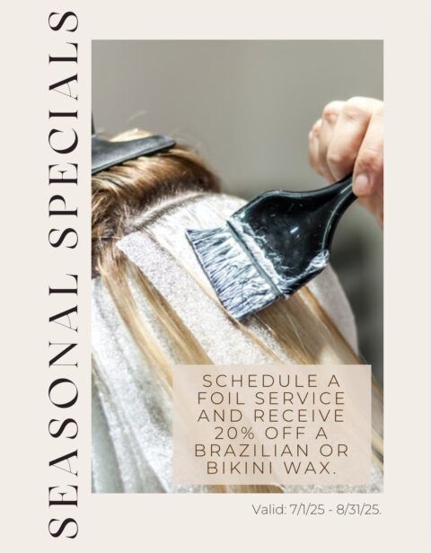 A woman is getting her hair dyed in a salon